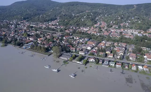 An aerial picture taken with a drone shows a flooded area and the swollen Danube River in Kisoroszi, Hungary, Wednesday, Sept. 18, 2024. (Gergely Janossy/MTI via AP)