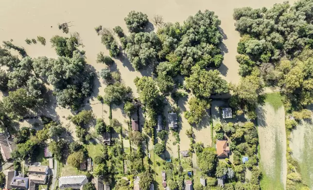 An aerial picture taken with a drone shows a flooded area and the swollen Danube River in Kisoroszi, Hungary, Wednesday, Sept. 18, 2024. (Gergely Janossy/MTI via AP)