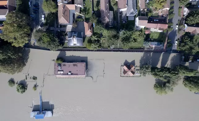 An aerial picture taken with a drone shows a flooded area and the swollen Danube River in Kisoroszi, Hungary, Wednesday, Sept. 18, 2024. (Gergely Janossy/MTI via AP)