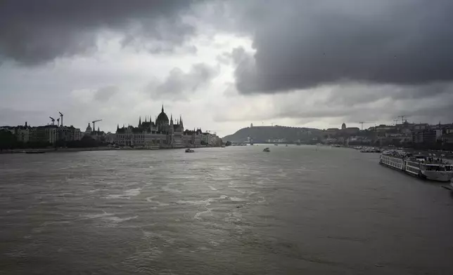 Dark clouds are seen over the Parliament building in Budapest, Hungary, during the flooding of the Danube river on Monday, Sept. 16, 2024. (AP Photo/Denes Erdos)