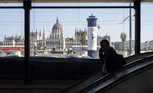 A man walks down to a metro station protected by sandbags as the Danube river floods it's banks, central Budapest, Hungary, Thursday, Sept. 19, 2024. (AP Photo/Denes Erdos)