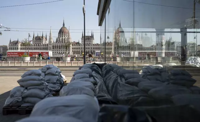 The reflection of the Parliament building seen in the metro station protected by sandbags after the Danube river floods it's banks, central Budapest, Hungary, Thursday, Sept. 19, 2024. (AP Photo/Denes Erdos)