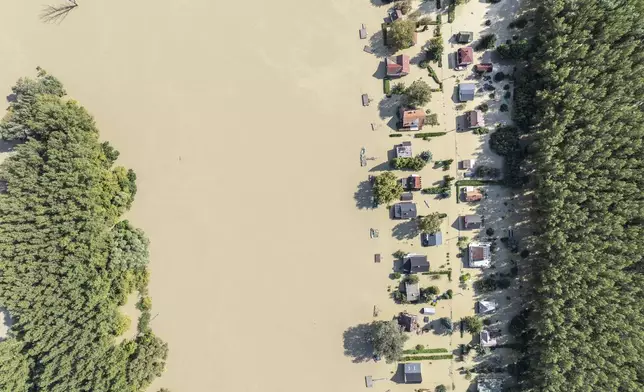 An aerial picture taken with a drone shows the flooded resort village of Venek and the swollen Danube River near Gyor, Hungary, Tuesday, September 17, 2024. (Gergely Janossy/MTI via AP)