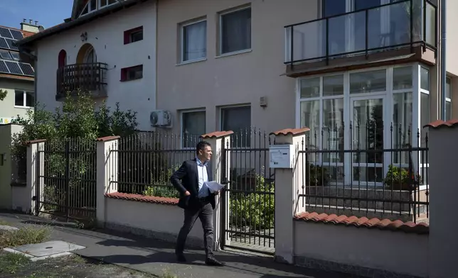 Előd Novak, a member of the National Assembly of Hungary, tries to enter to a house where a Hungarian company that allegedly manufactured pagers that exploded in Lebanon and Syria, is headquartered in Budapest Wednesday, Sept. 18, 2024. (AP Photo/Denes Erdos)