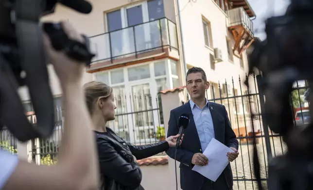 Előd Novak, a member of the National Assembly of Hungary, talks to the local media in front of a house where a Hungarian company that allegedly manufactured pagers that exploded in Lebanon and Syria, is headquartered in Budapest Wednesday, Sept. 18, 2024. (AP Photo/Denes Erdos)