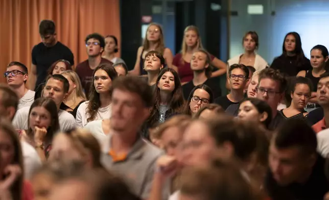 First-year students listen during an anatomy lecture using a live horse from Dr. Peter Sotonyi, rector of the University of Veterinary Medicine in Budapest, Hungary, using a live horse, Monday, Sept 9. 2024. (AP Photo/Denes Erdos)