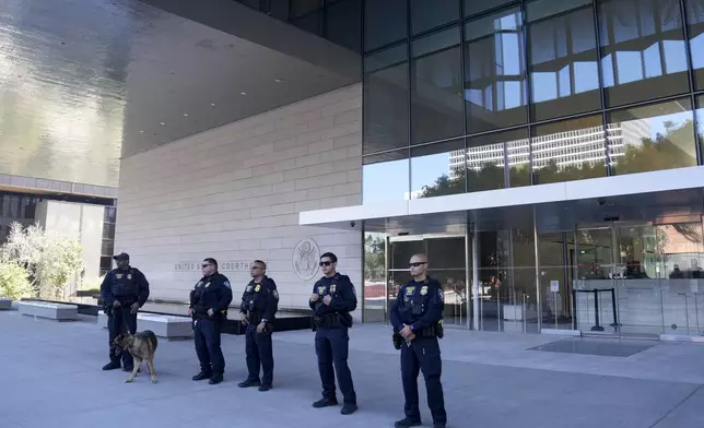 Police officers guard the entrance to a federal courthouse after Hunter Biden pleaded guilty in his felony federal tax case, Thursday, Sept. 5, 2024, in Los Angeles. (AP Photo/Eric Thayer)