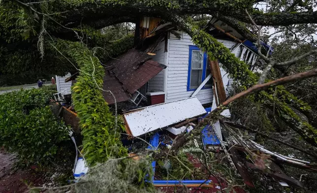 A damaged 100-year-old home is seen after an Oak tree landed on it after Hurricane Helene moved through the area, Friday, Sept. 27, 2024, in Valdosta, Ga. (AP Photo/Mike Stewart)