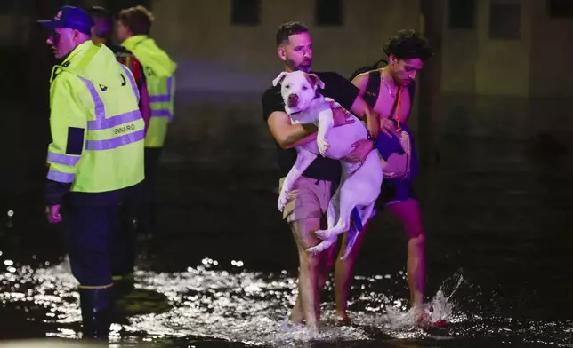 Residents are rescued from floodwaters in the aftermath of Hurricane Helene, Friday, Sept. 27, 2024 in Crystal River, Fla. (Luis Santana/Tampa Bay Times via AP)