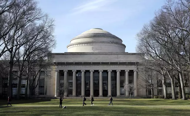 FILE - Students walk past the "Great Dome" atop Building 10 on the Massachusetts Institute of Technology campus in Cambridge, Mass, April 3, 2017. (AP Photo/Charles Krupa, File)