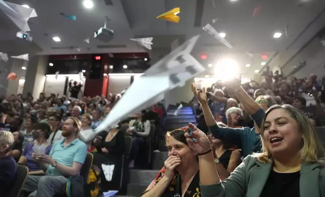 People in the audience throw paper airplanes toward the stage during a performance at the Ig Nobel Prize ceremony at Massachusetts Institute of Technology in Cambridge, Mass., Thursday, Sept. 12, 2024. (AP Photo/Steven Senne)