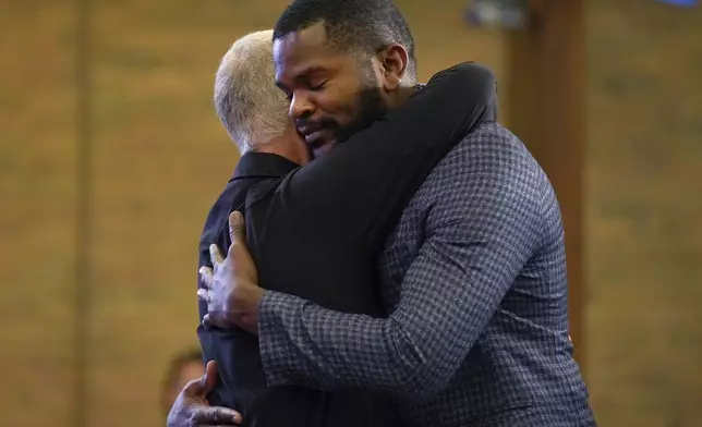 Carl Ruby, pastor at Central Christian Church, hugs Lindsay Aime during service, on Sunday, Sept. 15, 2024, in Springfield, Ohio. (AP Photo/Jessie Wardarski)