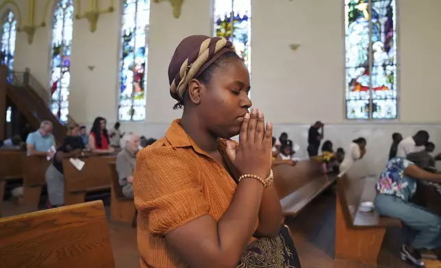 Marie Morette, a congregant of St Raphael Catholic church, prays during Mass in Springfield, Ohio, Sunday, Sept. 15, 2024. (AP Photo/Jessie Wardarski)