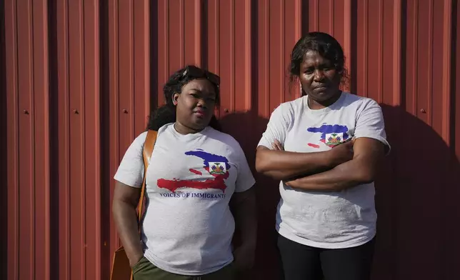 Mia Perez, left, an immigration lawyer, and Bernardette Dor, a pastor at the First Haitian Church, pose for a photo together after joining a prayer walk in support of their Haitian immigrant community in Springfield, Ohio, Saturday, Sept. 14, 2024. (AP Photo/Luis Andres Henao)