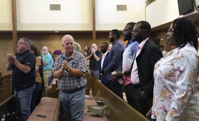 Central Christian Church congregants stand to applaud members of the Haitian community during service, on Sunday, Sept. 15, 2024, in Springfield, Ohio. (AP Photo/Jessie Wardarski)