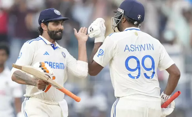 India's Ravichandran Ashwin celebrates scoring a century with Ravindra Jadeja, left, on the first day of the first cricket test match between India and Bangladesh, in Chennai, India, Thursday, Sept.19, 2024. (AP Photo/Mahesh Kumar A.)