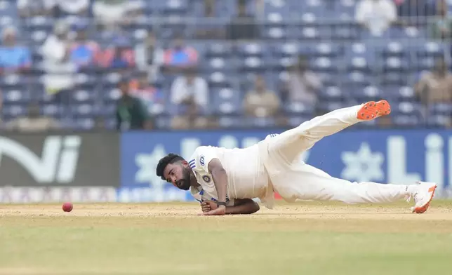 India's Mohammed Siraj dives while fielding off his own bowling on the fourth day of the first cricket test match between India and Bangladesh, in Chennai, India, Sunday, Sept. 22, 2024. (AP Photo/Mahesh Kumar A.)