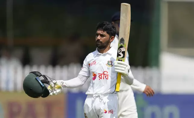 Bangladesh's Mominul Haque celebrates his century on the fourth day of the second cricket test match between Bangladesh and India in Kanpur, India, Monday, Sept. 30, 2024. (AP Photo/Ajit Solanki)