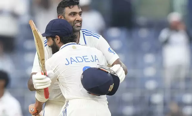 India's Ravichandran Ashwin celebrates after scoring a century with Ravindra Jadeja on the first day of the first cricket test match between India and Bangladesh, in Chennai, India, Thursday, Sept.19, 2024. (AP Photo/Mahesh Kumar A.)