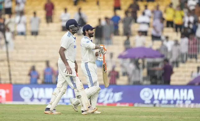 India's Ravichandran Ashwin, left, and Ravindra Jadeja leave the field at the end of the first day of the first cricket test match between India and Bangladesh, in Chennai, India, Thursday, Sept.19, 2024. (AP Photo/Mahesh Kumar A.)