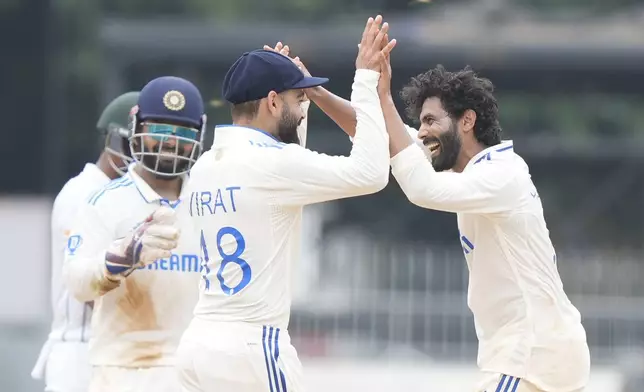 India's Ravindra Jadeja, right, celebrates with Virat Kohli the wicket of Bangladesh's captain Najmul Hossain Shanto on the fourth day of the first cricket test match between India and Bangladesh, in Chennai, India, Sunday, Sept. 22, 2024. (AP Photo/Mahesh Kumar A.)