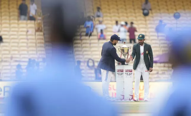 India's captain Rohit Sharma, left, and Bangladesh's captain Najmul Hossain Shanto greet each other and pose with trophy before the start of the first cricket test match between India and Bangladesh, in Chennai, India, Thursday, Sept.19, 2024. (AP Photo/Mahesh Kumar A.)