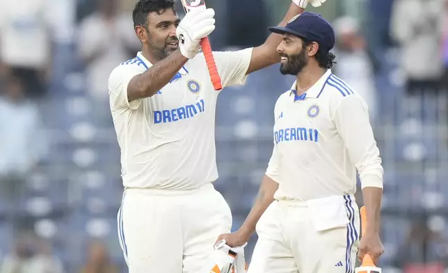 India's Ravichandran Ashwin celebrates after scoring a century with Ravindra Jadeja, right, on the first day of the first cricket test match between India and Bangladesh, in Chennai, India, Thursday, Sept.19, 2024. (AP Photo/Mahesh Kumar A.)