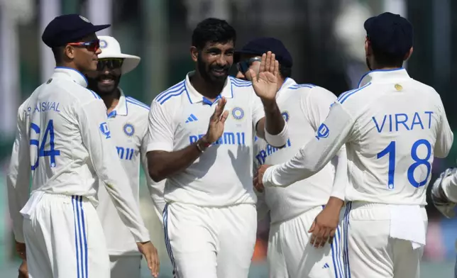 India's Jasprit Bumrah, center, celebrate with teammates the wicket of Bangladesh's Mushfiqur Rahim on the fourth day of the second cricket test match between Bangladesh and India in Kanpur, India, Monday, Sept. 30, 2024. (AP Photo/Ajit Solanki)