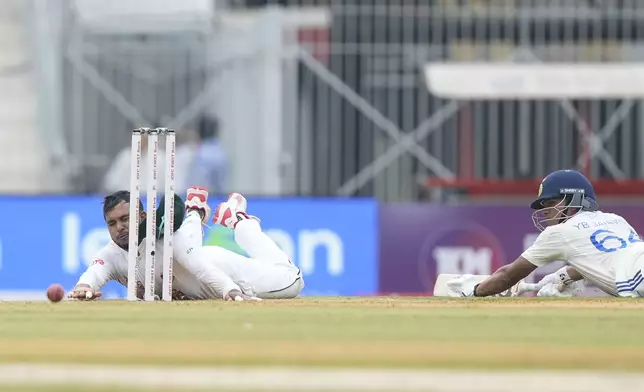 Bangladesh's Zakir Hasan dives to make an unsuccessful attempt to run out of India's Yashasvi Jaiswal on the first day of the first cricket test match between India and Bangladesh, in Chennai, India, Thursday, Sept.19, 2024. (AP Photo/Mahesh Kumar A.)