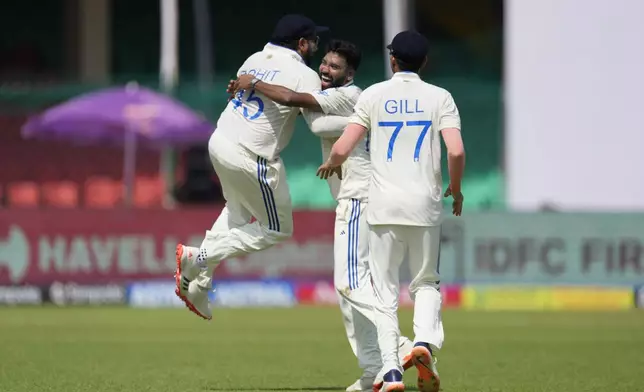 India's captain Rohit Sharma, left and Mohammed Siraj, center, celebrate the wicket of Bangladesh's Litton Das on the fourth day of the second cricket test match between Bangladesh and India in Kanpur, India, Monday, Sept. 30, 2024. (AP Photo/Ajit Solanki)