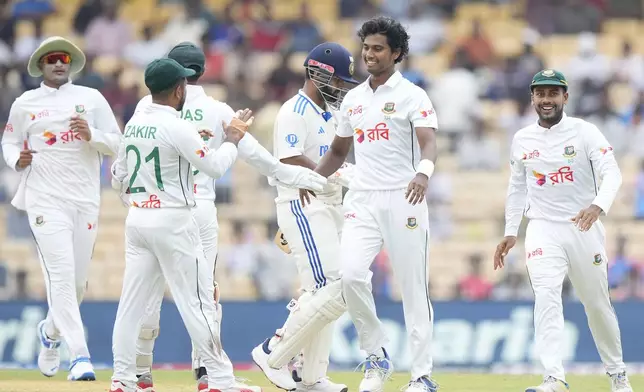 Bangladesh's Hasan Mahmud celebrates the wicket of India's Rishabh Pant, centre, on the first day of the first cricket test match between India and Bangladesh, in Chennai, India, Thursday, Sept.19, 2024. (AP Photo/Mahesh Kumar A.)