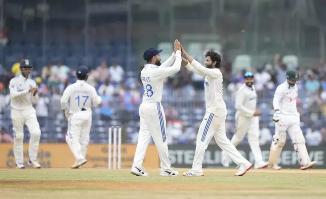 India's Ravindra Jadeja, centre, celebrates with Virat Kohli the wicket of Bangladesh's Litton Das on the fourth day of the first cricket test match between India and Bangladesh, in Chennai, India, Sunday, Sept. 22, 2024. (AP Photo/Mahesh Kumar A.)