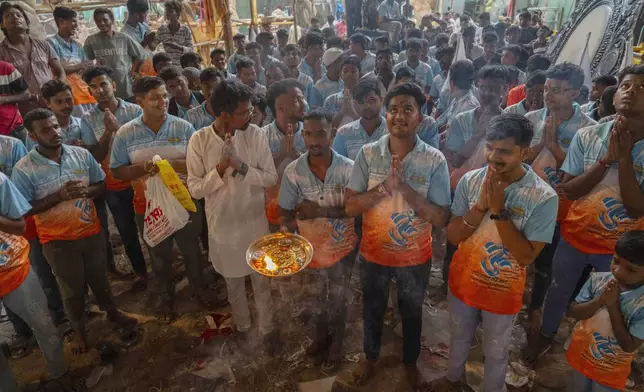 Devotees offers prayers to Idols of the elephant-headed Hindu god Ganesh before they are transported to a place of worship during the Ganesh Chaturti festival in Mumbai, India, Wednesday, Sept. 4, 2024. (AP Photo/Rafiq Maqbool)