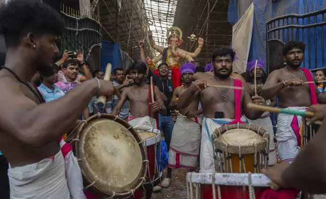 An Idol of the elephant-headed Hindu god Ganesh is transported through a street to a place of worship for the Ganesh Chaturti festival in Mumbai, India, Wednesday, Sept. 4, 2024. (AP Photo/Rafiq Maqbool)