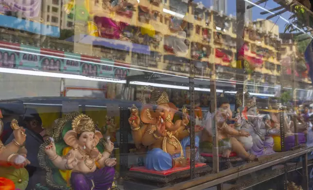 Idols of elephant-headed Hindu god Ganesha are displayed for sale at a shop during the Ganesh Chaturthi festival celebrations in Mumbai, India, Saturday, Sept. 7, 2024. (AP Photo/Rafiq Maqbool)