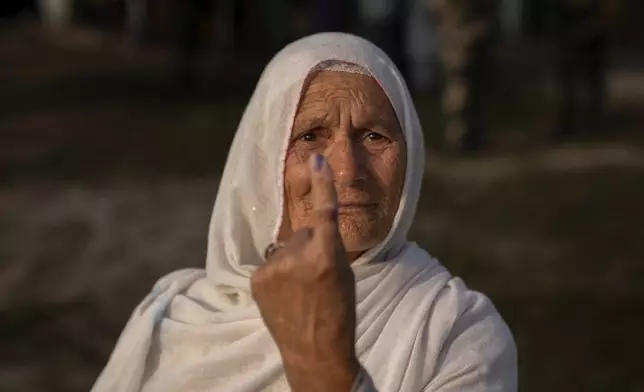 Sayeeda Begum shows the indelible ink mark on her index finger after casting her vote in the outskirts of Srinagar, Indian controlled Kashmir, Wednesday, Sept. 25, 2024. (AP Photo/Dar Yasin)