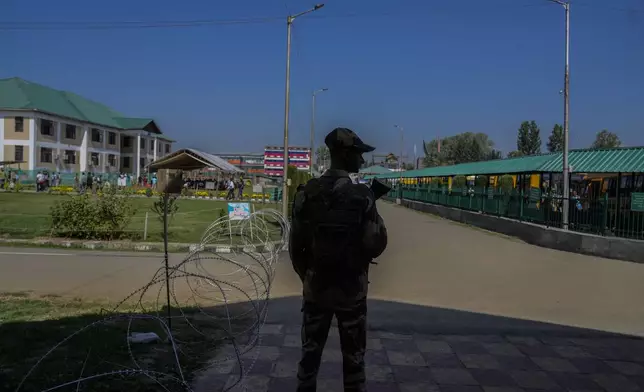 Indian paramilitary soldier guard a venue for distribution of election material, in Pulwama south of Srinagar, Indian controlled Kashmir, Tuesday, Sept. 17, 2024. (AP Photo/Mukhtar Khan)