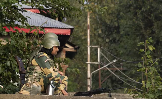 Indian paramilitary soldiers guard a polling station during the second phase of the assembly election in the outskirts of Srinagar, Indian controlled Kashmir, Wednesday, Sept. 25, 2024. (AP Photo/Dar Yasin)