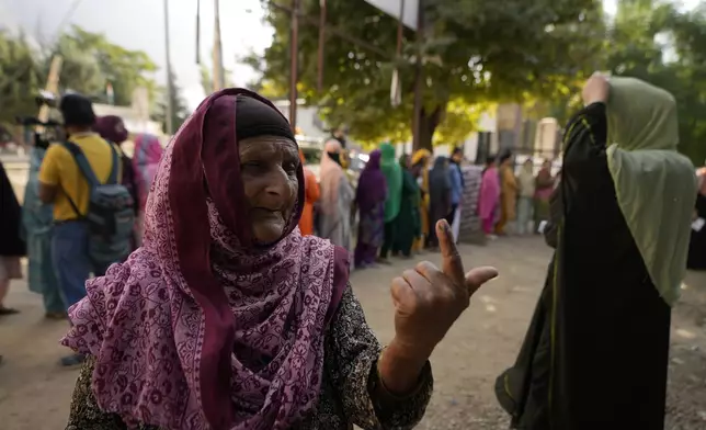 A woman shows the indelible ink mark on her finger after casting her vote during the first phase of the Jammu and Kashmir assembly election, in Kishtwar, India, Wednesday, Sept. 18, 2024. (AP Photo/Channi Anand)