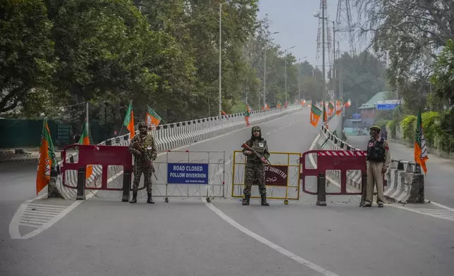 Indian paramilitary soldiers and a policeman guard at a closed road ahead of Indian Prime Minister Narendra Modi's visit in Srinagar, Indian controlled Kashmir Thursday, Sept. 19, 2024. (AP Photo/Mukhtar Khan)