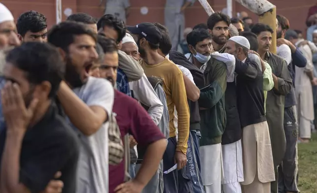 Kashmiri's queue up at a polling booth to cast their vote during the second phase of the assembly election in the outskirts of Srinagar, Indian controlled Kashmir, Wednesday, Sept. 25, 2024. (AP Photo/Dar Yasin)