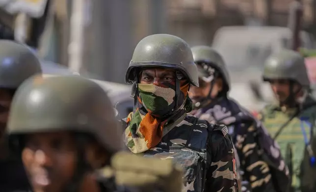 Indian paramilitary soldiers arrive to guard outside the venue for distribution of election material, in Pulwama, south of Srinagar, Indian controlled Kashmir, Tuesday, Sept. 17, 2024. (AP Photo/Mukhtar Khan)