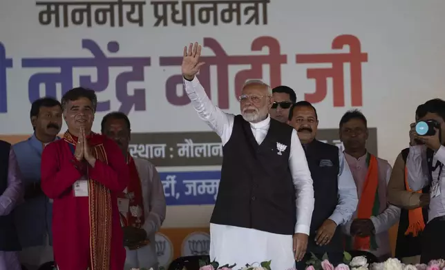 FILE- Indian Prime Minister Narendra Modi, center, waves to supporters during a campaign rally of Jammu and Kashmir Assembly elections in Jammu, India, Sept. 28, 2024. (AP Photo/Channi Anand, File)