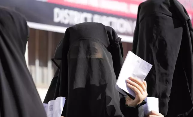 Muslim women voter queue up to cast their vote at a polling booth during the first phase of the Jammu and Kashmir assembly election, in Kishtwar, India, Wednesday, Sept. 18, 2024. (AP Photo/Channi Anand)