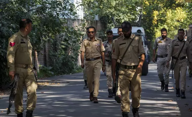 Indian policemen patrol as they guard near a venue for distribution of election material, ahead of the second phase of voting for choosing a local government in Indian-controlled Kashmir, in Srinagar, Tuesday, Sept. 24 , 2024. (AP Photo/Mukhtar Khan)