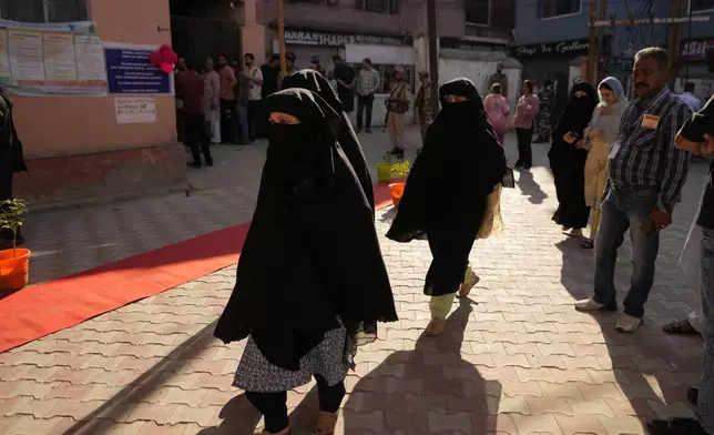 Muslim women arrive for cast their vote at a polling booth during the first phase of the Jammu and Kashmir assembly election, in Kishtwar, India, Wednesday, Sept. 18, 2024. (AP Photo/Channi Anand)