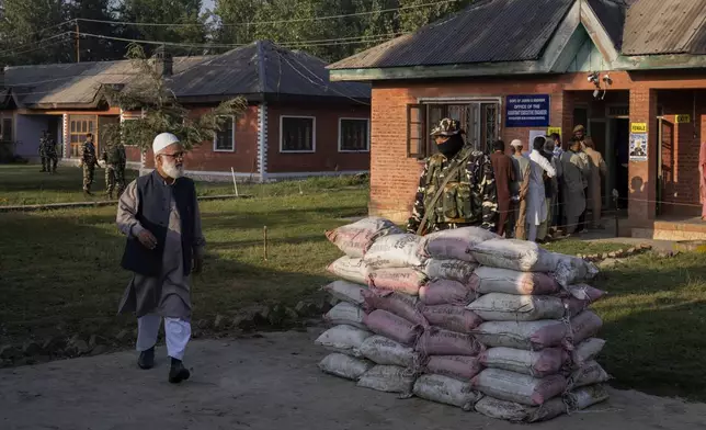 A Kashmiri man walks back after casting his vote at a polling booth in Marval, south of Srinagar, Indian controlled Kashmir, Wednesday, Sept.18, 2024. (AP Photo/Dar Yasin)