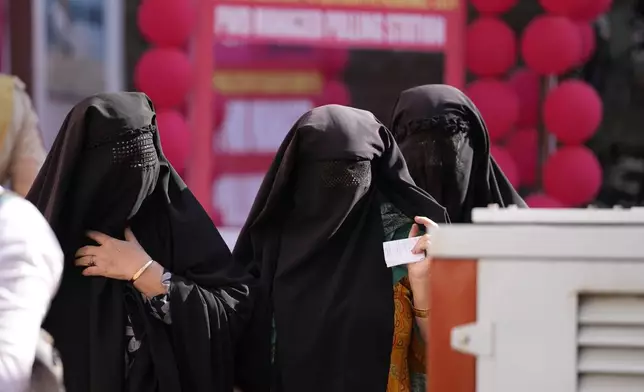 Muslim women voter queue up to cast their vote at a polling booth during the first phase of the Jammu and Kashmir assembly election, in Kishtwar, India, Wednesday, Sept. 18, 2024. (AP Photo/Channi Anand)