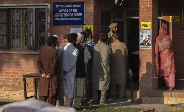 Kashmiri's queue up at a polling booth to cast their vote in Marval, south of Srinagar, Indian controlled Kashmir, Wednesday, Sept. 18, 2024. (AP Photo/Dar Yasin)