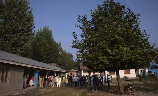 Kashmiri's queue up at a polling booth to cast their vote during the second phase of the assembly election in the outskirts of Srinagar, Indian controlled Kashmir, Wednesday, Sept. 25, 2024. (AP Photo/Dar Yasin)